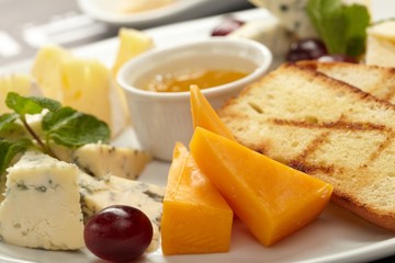 Cheese plate with grapes and honey