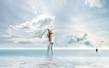 A young female is enjoying the wind white standing in the water