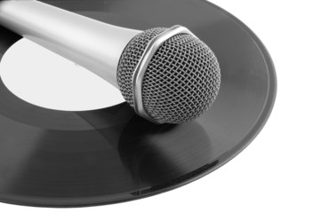 Microphone laying on vinyl records isolated