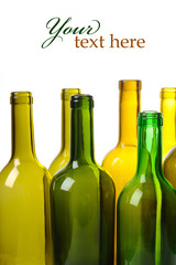Many empty green wine bottles isolated on white background