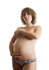Fototapeta premium naked young woman holding pregnant belly