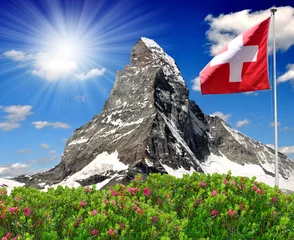 Fotobehang Beautiful mountain Matterhorn with Swiss flag - Swiss Alps © vencav