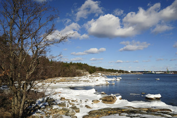 March sea landscape with industry harbor in horizon