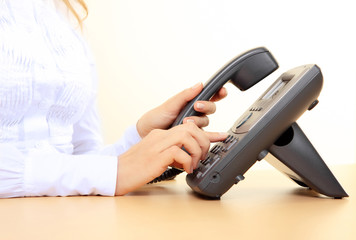 Girl's hands dialing a number
