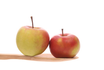 apples on a wooden spoon isolated on a white background