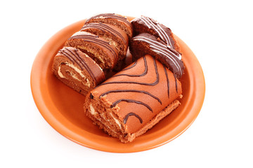 Swiss roll   on the  dish on a white background