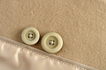 Two buttons on wool fabric