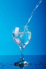 Glass with water and jug