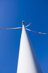 Wind turbine against blue sky