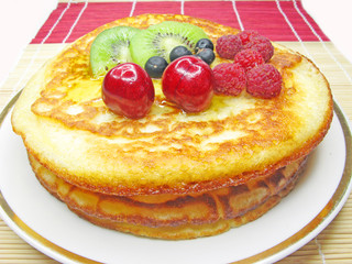 sweet pancakes with fruits in syrup