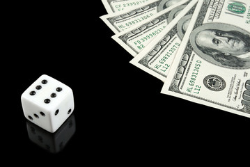 White dice and money on black background