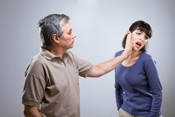 Man slapping his wife face