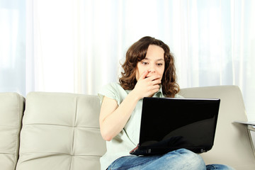 Young Woman on Couch with Laptop