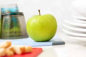 Green tasty apple on the table