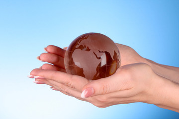 Crystal ball on hand. blue background