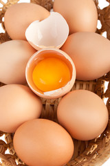 Macro of brown eggs inside wooden basket