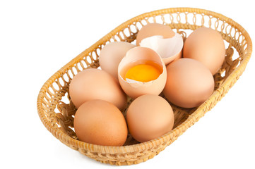 Macro of brown eggs inside wooden basket