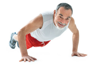 senior man doing push-ups exercise in gym