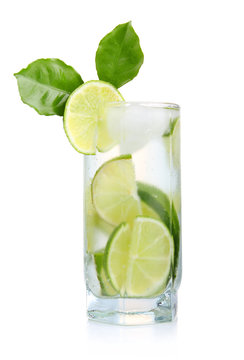 Full glass of fresh cool tonic with lime fruits isolated