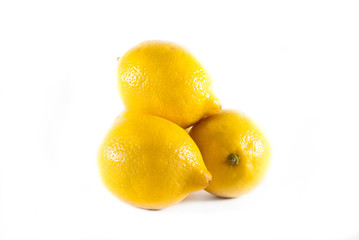 Group of yellow lemons stacked on a white isolated background