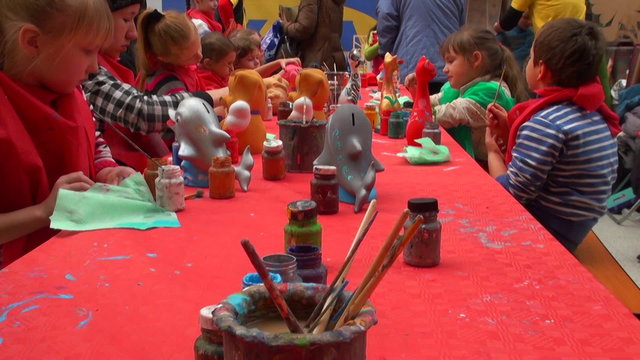girl paints a toy