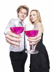 Young couple toasting with pink drink