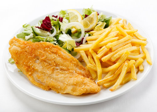 Fish dish - fried fish fillet, French fries  with vegetables