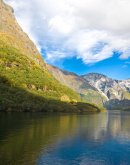 Naklejka na ściany i meble Norwegian fjords in autumn: Mountains and sky