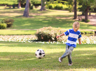 Boy playing football in the park