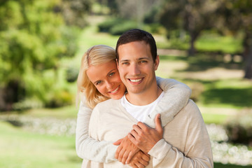 Woman hugging her boyfriend in the park