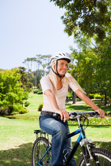 Fototapeta premium Woman in the park with her bike