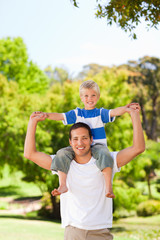Obraz premium Man giving son a piggyback