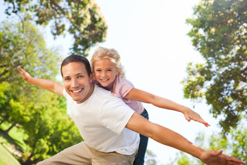 Father playing with his daughter in the park