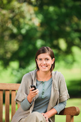 Woman phoning on the bench