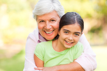 Fototapeta premium Grandmother hugging her granddaughter