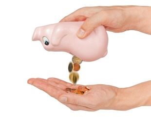 Coins falling into hand from coin bank isolated on white