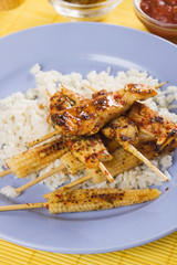 Asian skewed chicken with rice and baby corn