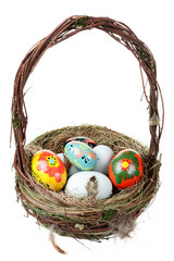 basket with Easter eggs isolated on white