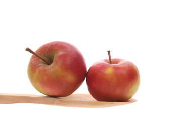 apples on a wooden spoon isolated on a white background