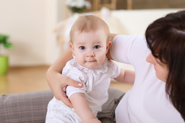 a young mother with her infant baby at home