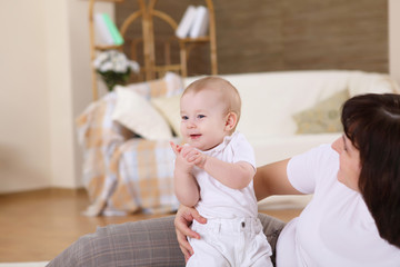 a young mother with her infant baby at home