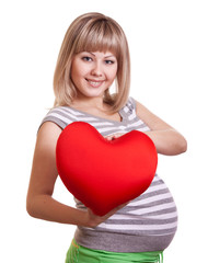 Happy pregnant woman hold red heart in hands
