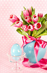 spring tulip flowers with ceramic easter egg