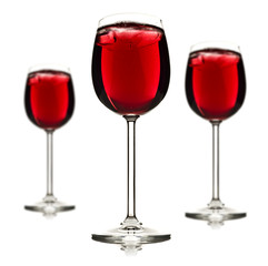 Three wine glasses with red fruit juice and ice