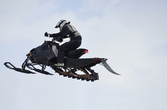 Russia, Samara. Snowmobile rider flying high air