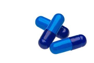 Three blue capsules over white