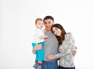 Fototapeta na wymiar mother, father and their child together in studio