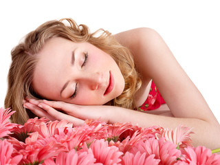 Obraz na płótnie Canvas Young woman sleeping on flowers.