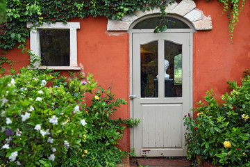 Fototapeta na wymiar Italian style Window and Door with flower bush