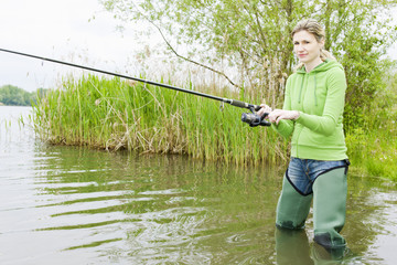 woman fishing in pond